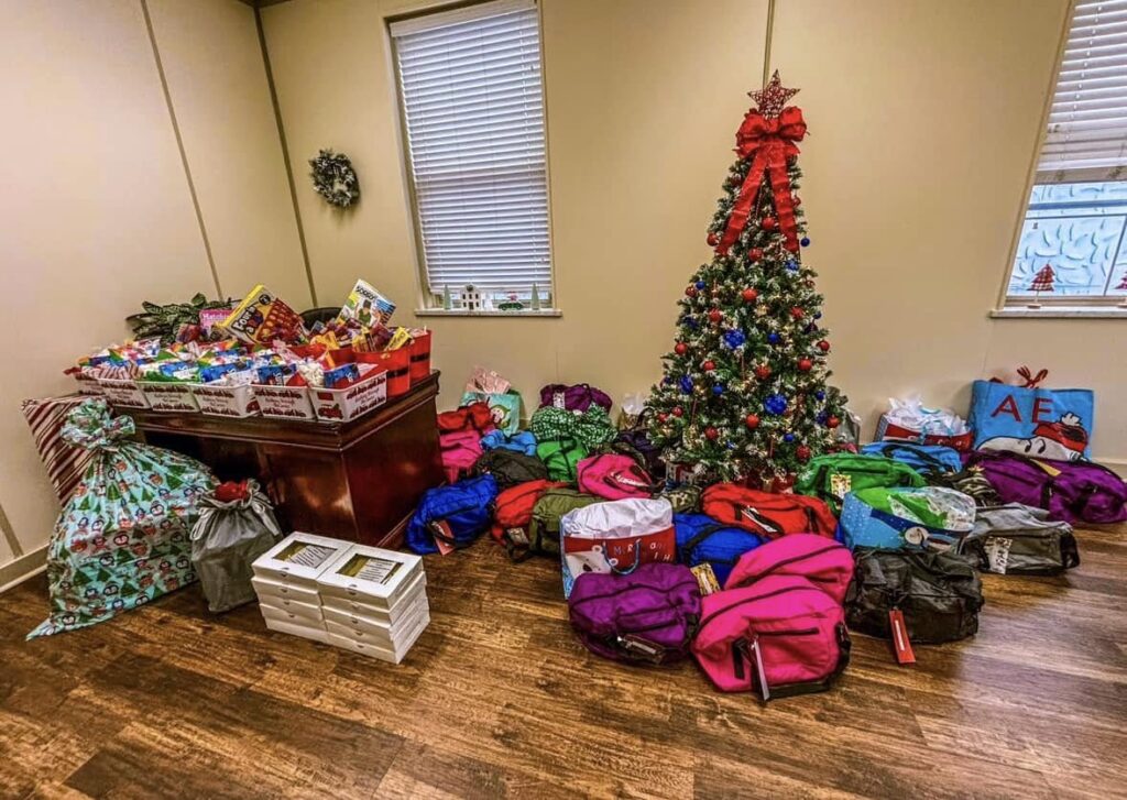 Christmas tree with lots of gifts under the tree, taken in the office of CASA SKY